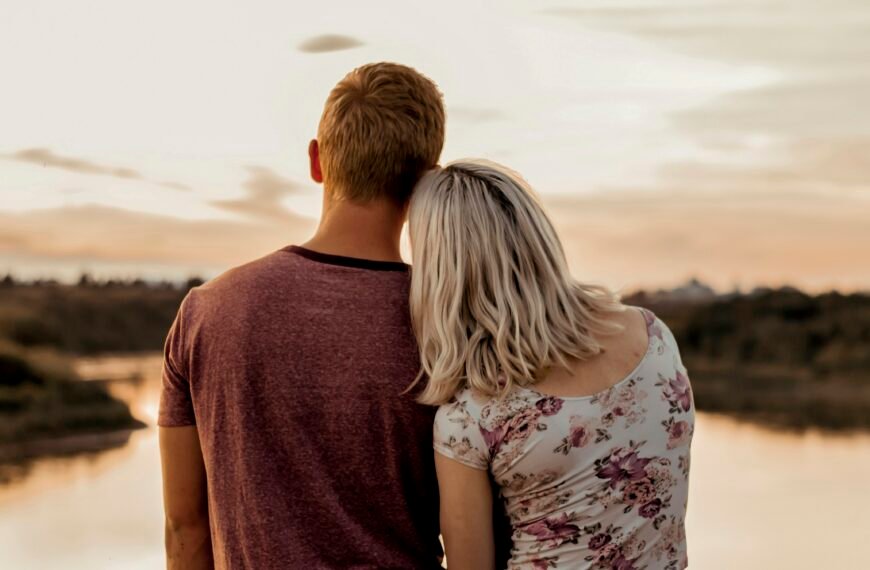 man and woman standing on brown field during daytime